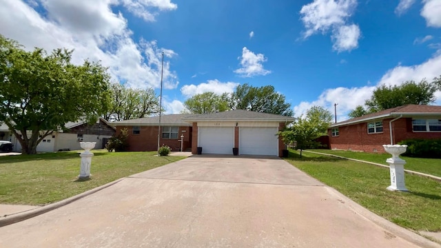 ranch-style house featuring concrete driveway, an attached garage, and a front yard