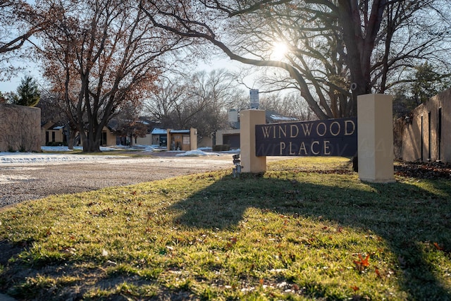 community / neighborhood sign with a lawn