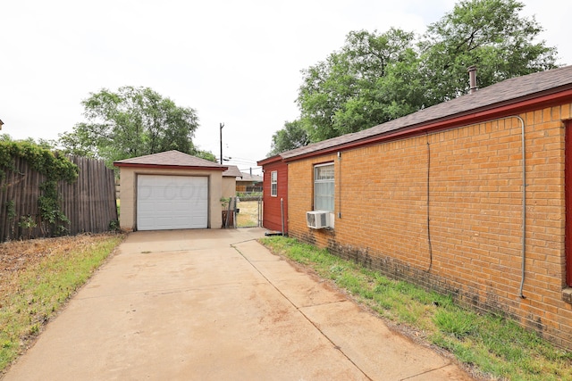 1219 S Kentucky St, Amarillo, TX 79102 - view of property exterior with concrete driveway, brick siding, cooling unit, an outdoor structure, and a garage