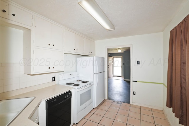 1219 S Kentucky St, Amarillo, TX 79102 - kitchen with white appliances, white cabinetry, light countertops, light tile patterned floors, and a ceiling fan