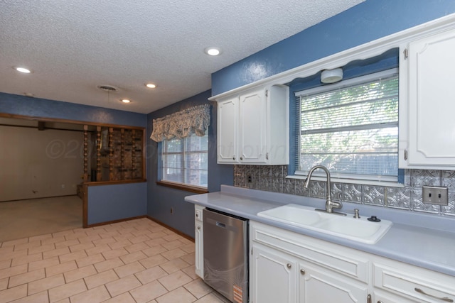 5614 Tranquil Cir, Amarillo, TX 79109 - kitchen featuring stainless steel dishwasher, a textured ceiling, white cabinets, light countertops, and recessed lighting