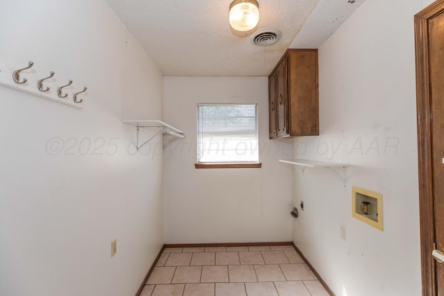 5614 Tranquil Cir, Amarillo, TX 79109 - laundry room with a textured ceiling, cabinet space, hookup for a washing machine, and light tile patterned floors
