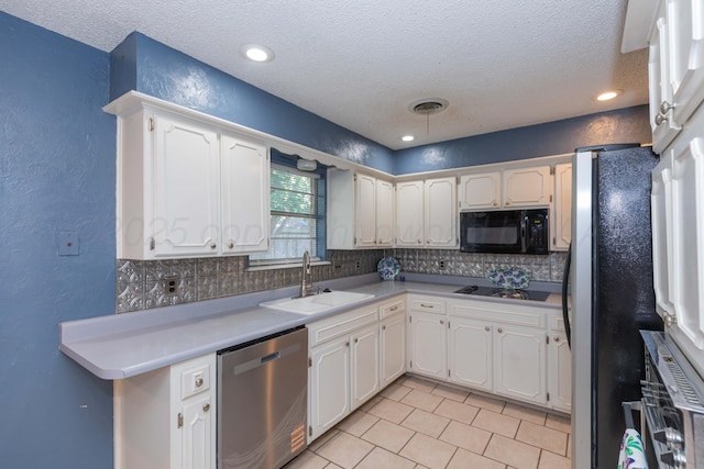 5614 Tranquil Cir, Amarillo, TX 79109 - kitchen featuring stainless steel appliances, a textured wall, tasteful backsplash, a textured ceiling, and light tile patterned floors