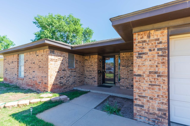 5614 Tranquil Cir, Amarillo, TX 79109 - doorway to property featuring brick siding and an attached garage