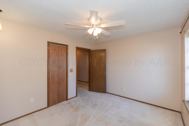5614 Tranquil Cir, Amarillo, TX 79109 - unfurnished bedroom with light carpet, ceiling fan, a closet, and a textured ceiling