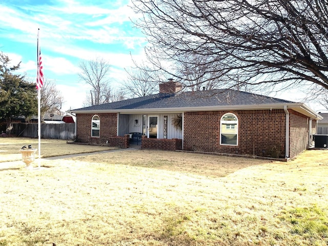 ranch-style home featuring central AC and a front yard