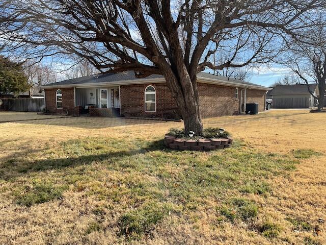 rear view of house featuring a lawn