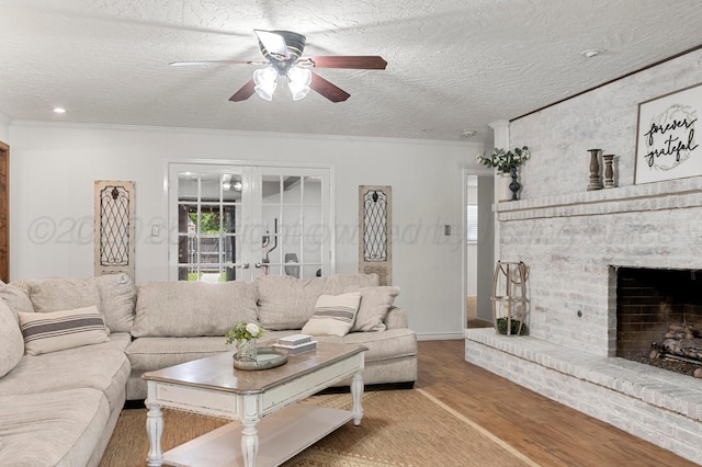 2428 N Fir St, Pampa, TX 79065 - living area with wood finished floors, ceiling fan, ornamental molding, a textured ceiling, and a brick fireplace
