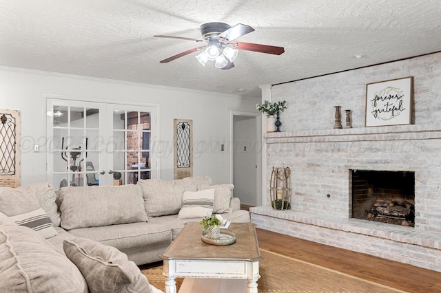 2428 N Fir St, Pampa, TX 79065 - living room featuring french doors, ceiling fan, ornamental molding, wood finished floors, and a brick fireplace
