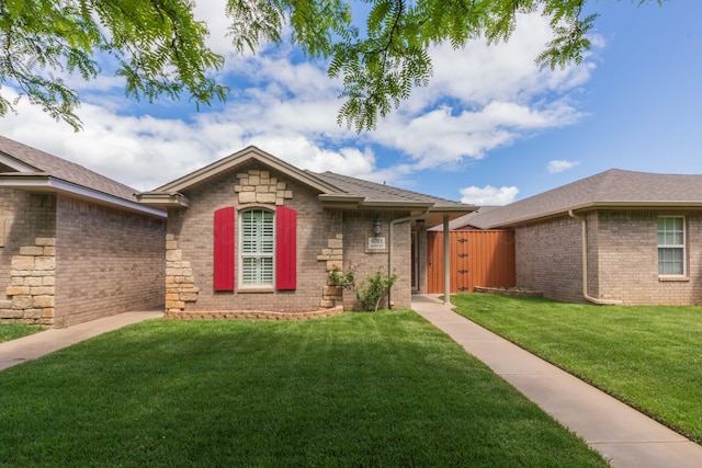 6703 Mosley St, Amarillo, TX 79119 - single story home featuring brick siding, a shingled roof, a gate, and stone siding
