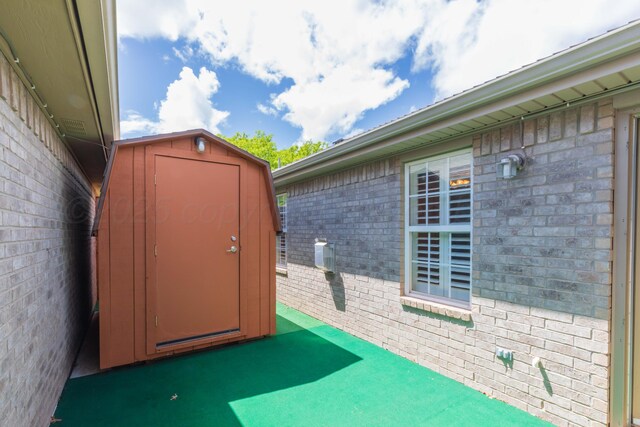 6703 Mosley St, Amarillo, TX 79119 - view of patio / terrace with a storage unit and an outdoor structure