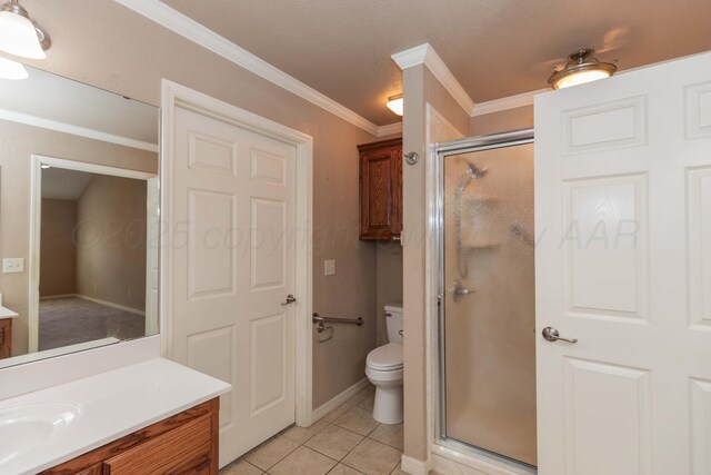 6703 Mosley St, Amarillo, TX 79119 - full bath featuring vanity, a shower stall, toilet, tile patterned flooring, and crown molding