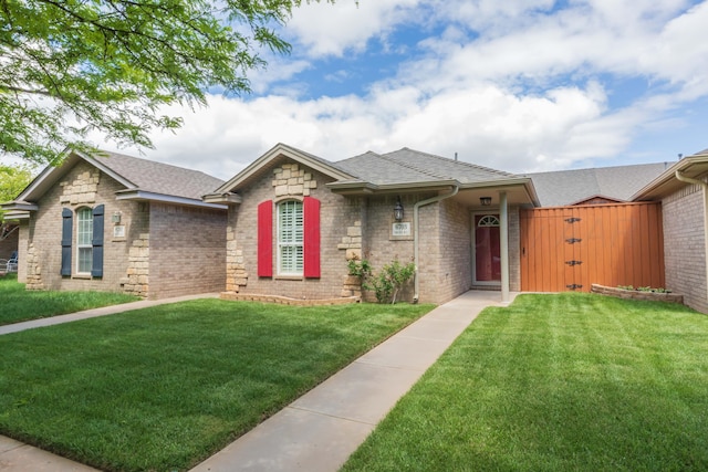 6703 Mosley St, Amarillo, TX 79119 - ranch-style home with a front yard, a shingled roof, and brick siding