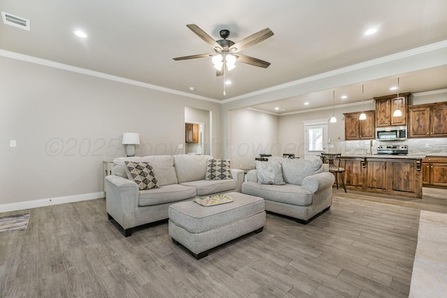 7611 Crestline Dr, Amarillo, TX 79119 - living room with light wood-style flooring, a ceiling fan, ornamental molding, and recessed lighting