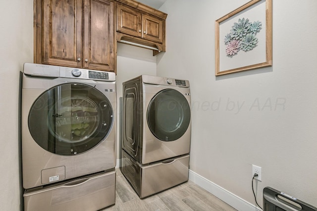 7611 Crestline Dr, Amarillo, TX 79119 - washroom featuring cabinet space, washer and dryer, and light wood-style flooring