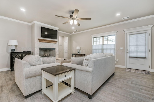 7611 Crestline Dr, Amarillo, TX 79119 - living area with ceiling fan, light wood-style floors, a stone fireplace, ornamental molding, and recessed lighting