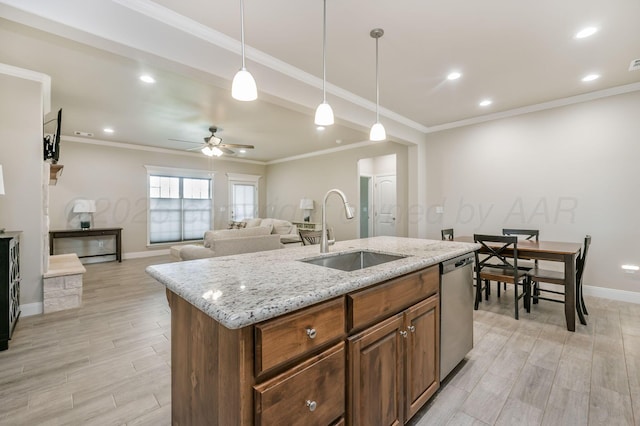 7611 Crestline Dr, Amarillo, TX 79119 - kitchen with stainless steel dishwasher, light wood-style floors, ceiling fan, decorative light fixtures, and brown cabinets