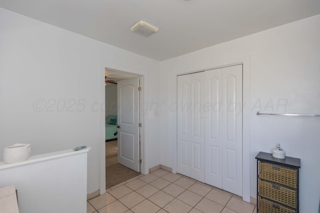 bedroom with a closet and light tile patterned floors