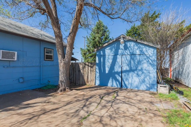 view of shed featuring fence