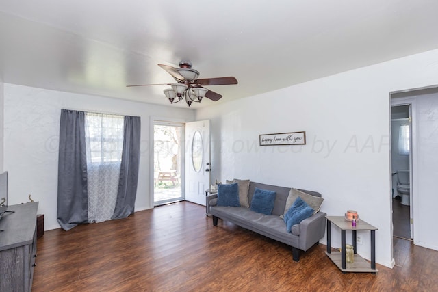 living area with ceiling fan and wood finished floors