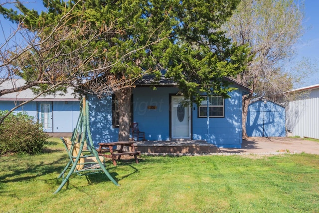 back of property with a lawn
