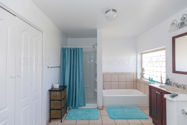 full bath featuring tile patterned flooring, vanity, a garden tub, and a stall shower
