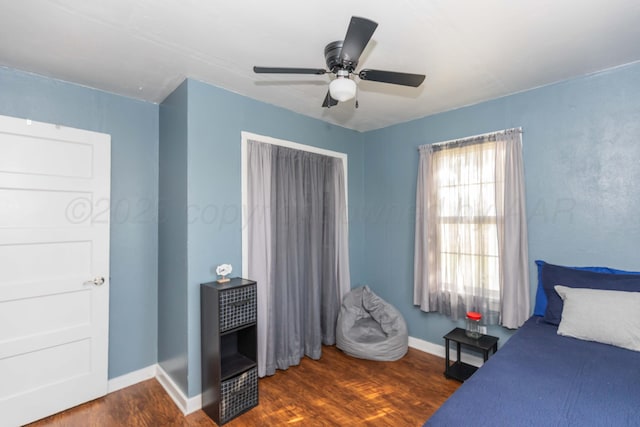 bedroom with baseboards, a ceiling fan, and wood finished floors