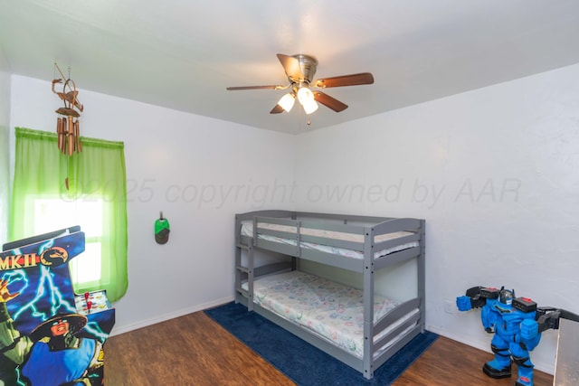 bedroom featuring ceiling fan, wood finished floors, and baseboards