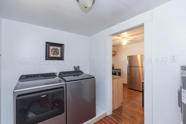 laundry room featuring laundry area, separate washer and dryer, wood finished floors, and ceiling fan