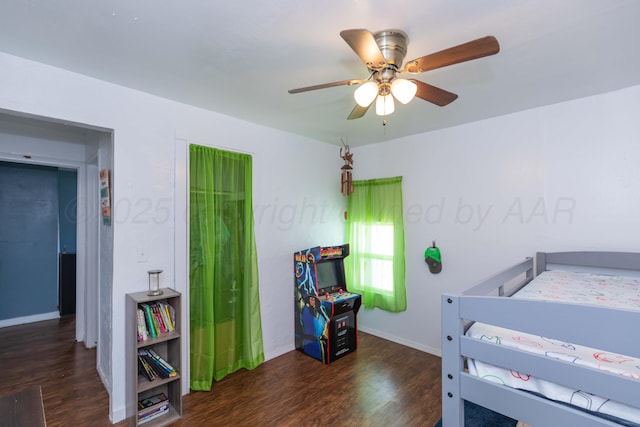 bedroom with wood finished floors, ceiling fan, and baseboards