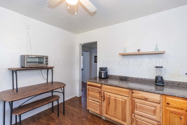kitchen featuring baseboards, open shelves, ceiling fan, dark wood-type flooring, and a toaster