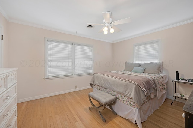 bedroom with light wood-style floors, baseboards, crown molding, and ceiling fan