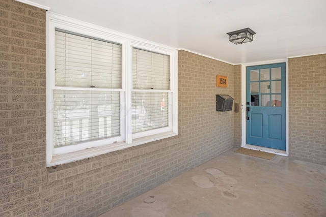 property entrance featuring brick siding