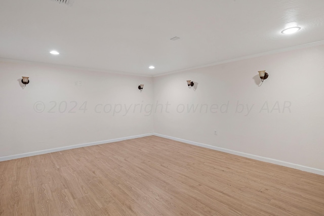 spare room featuring crown molding, light wood-style flooring, recessed lighting, and baseboards