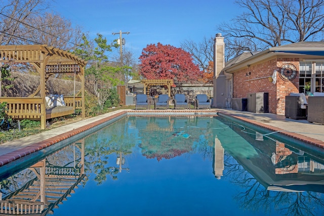 view of pool with a pergola and a patio