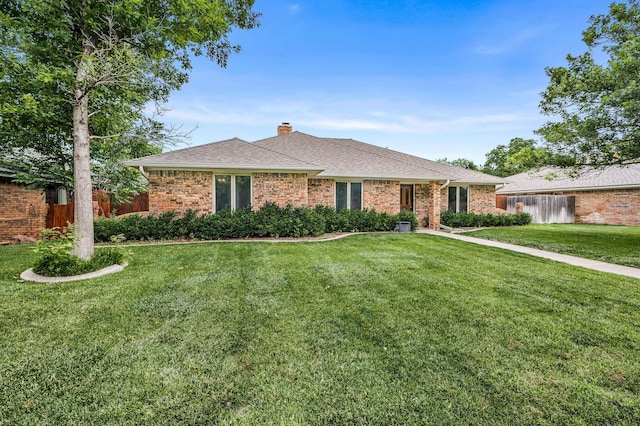 7502 Tripp Ave, Amarillo, TX 79121 - single story home with a chimney, brick siding, and a shingled roof