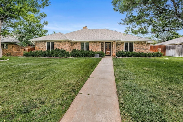 7502 Tripp Ave, Amarillo, TX 79121 - single story home featuring a front yard, a chimney, and brick siding