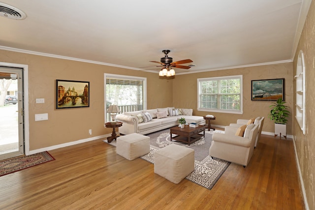 living room with ceiling fan, ornamental molding, and light hardwood / wood-style flooring