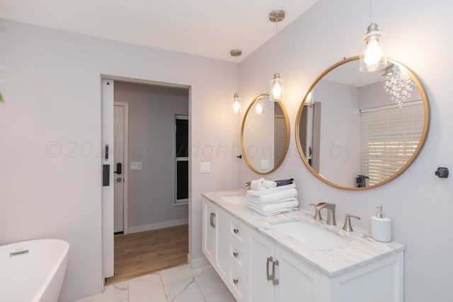 3002 S Polk St, Amarillo, TX 79109 - full bathroom featuring double vanity, a freestanding bath, marble finish flooring, and baseboards