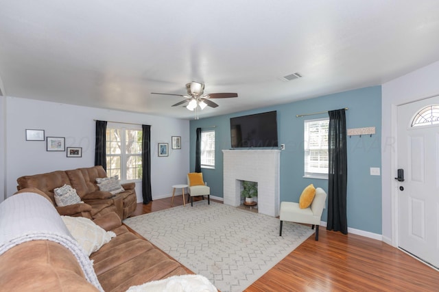 3002 S Polk St, Amarillo, TX 79109 - living room featuring ceiling fan, a fireplace, wood finished floors, and baseboards