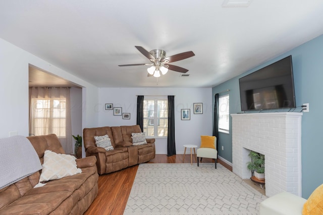 3002 S Polk St, Amarillo, TX 79109 - living area with a ceiling fan, wood finished floors, a brick fireplace, and baseboards