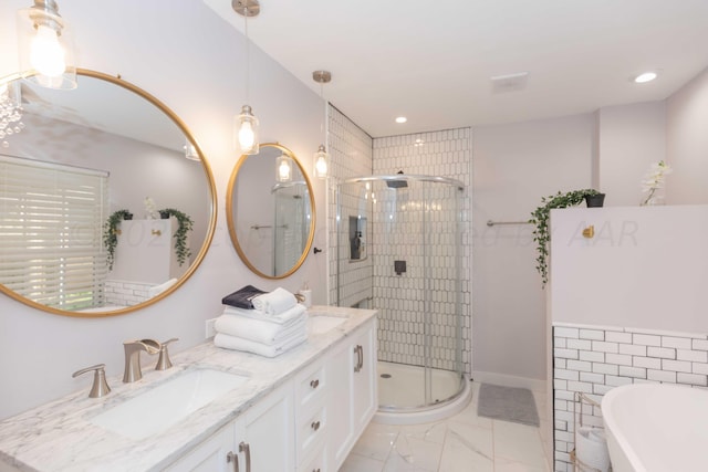 3002 S Polk St, Amarillo, TX 79109 - bathroom featuring double vanity, a shower stall, a freestanding tub, marble finish flooring, and recessed lighting