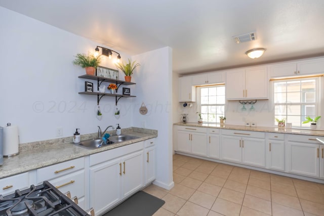 3002 S Polk St, Amarillo, TX 79109 - kitchen with a sink, white cabinets, light countertops, open shelves, and light tile patterned floors