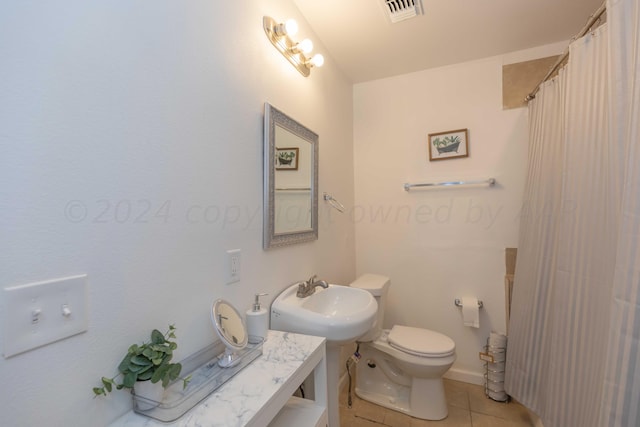 3002 S Polk St, Amarillo, TX 79109 - bathroom featuring a sink, tile patterned floors, and toilet