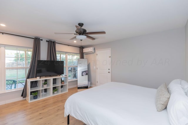3002 S Polk St, Amarillo, TX 79109 - bedroom featuring a wall unit AC, light wood finished floors, and baseboards