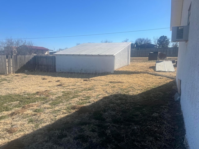 view of yard with fence and an outbuilding