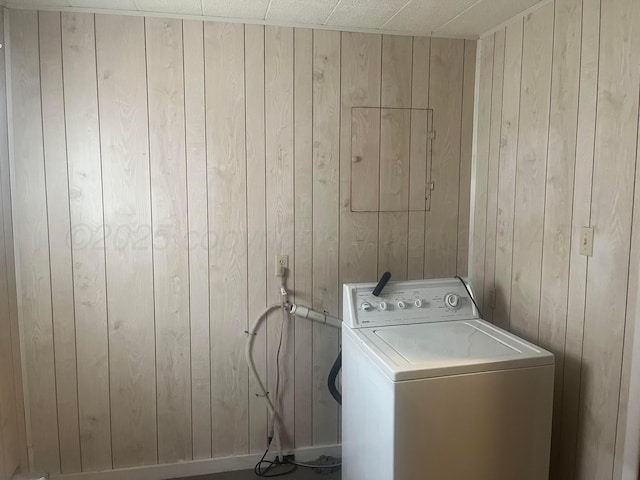 laundry room featuring washer / dryer, laundry area, and wooden walls