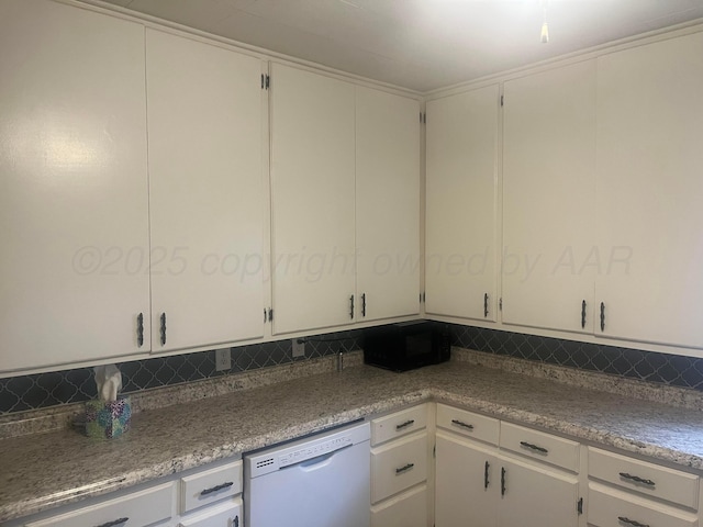 kitchen with tasteful backsplash, white cabinetry, and white dishwasher