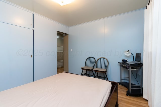 bedroom with light wood-style floors and visible vents