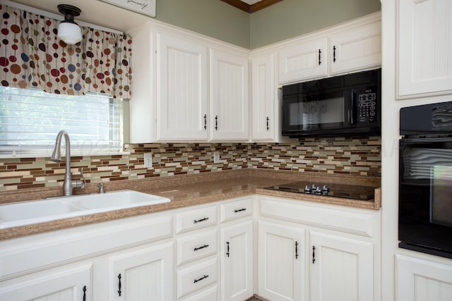 3729 Wayne St, Amarillo, TX 79109 - kitchen with black appliances, decorative backsplash, and white cabinets